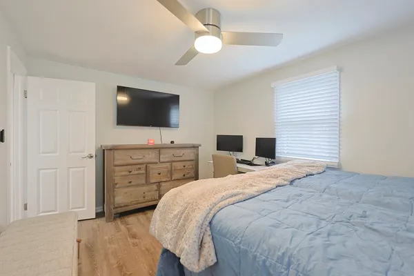 a bedroom with a bed and a flat screen tv