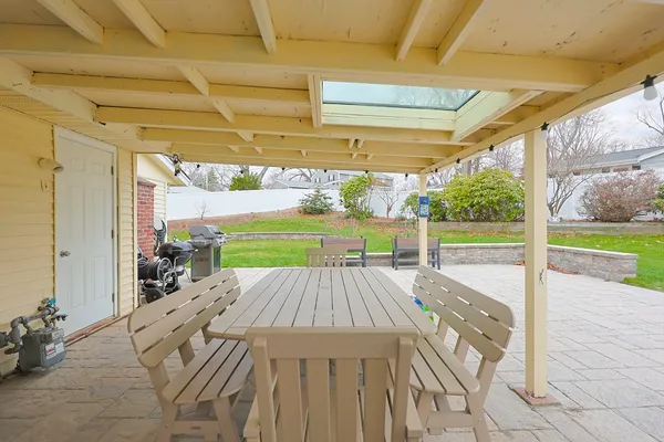 a view of a patio with a table and chairs