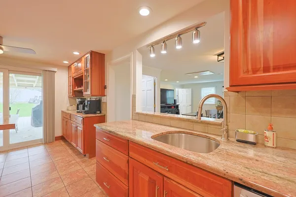 a kitchen with stainless steel appliances granite countertop a sink and cabinets
