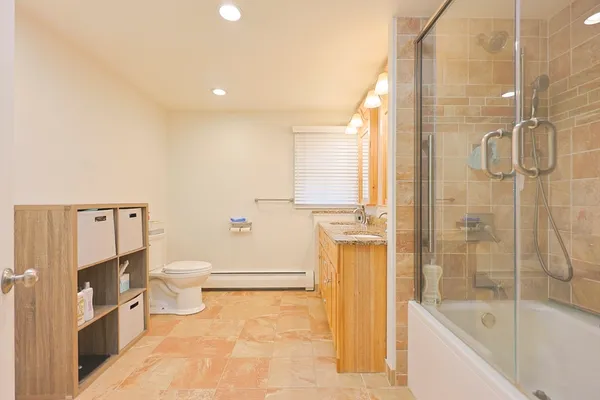 a bathroom with a bathtub and a toilet