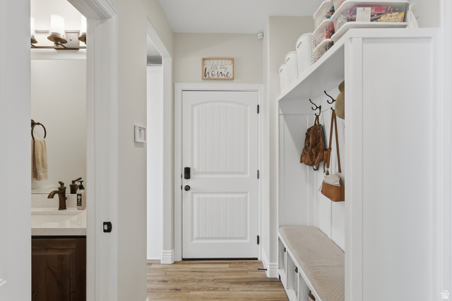 10676 Urban Rdg Cove South Jordan, UT 84095 - Photo 24 of 48 Entryway featuring wood-finish flooring and a white built-in storage bench with hooks