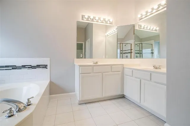 a bathroom with a tub and a shower