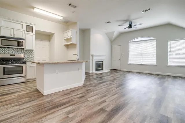 a view of a kitchen with granite countertop cabinets and steel stainless steel appliances