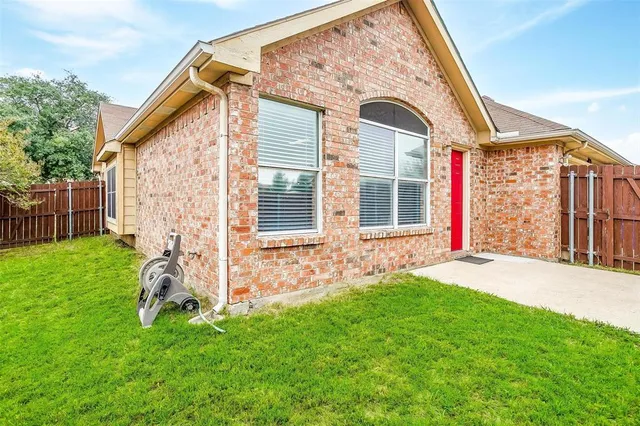 a view of a backyard with wooden fence