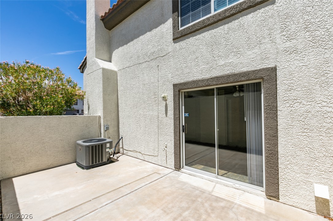 200 Luninborg Street Henderson, NV 89074 - Photo 32 of 40 A private concrete patio area provides outdoor living space, accessible through a large sliding glass door.
