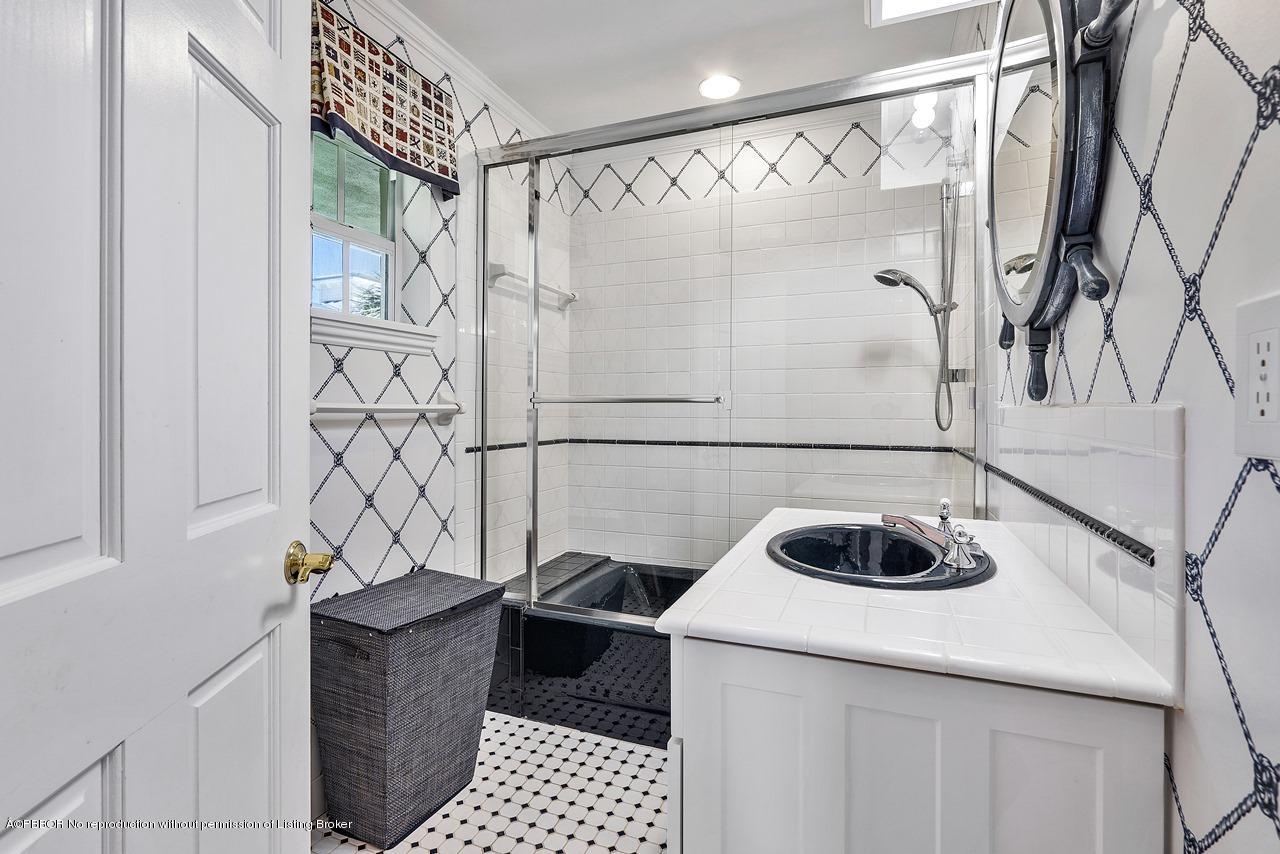 57 River Drive Ocean Ridge, FL 33435 - Photo 18 of 43 a bathroom with a shower curtain and a sink