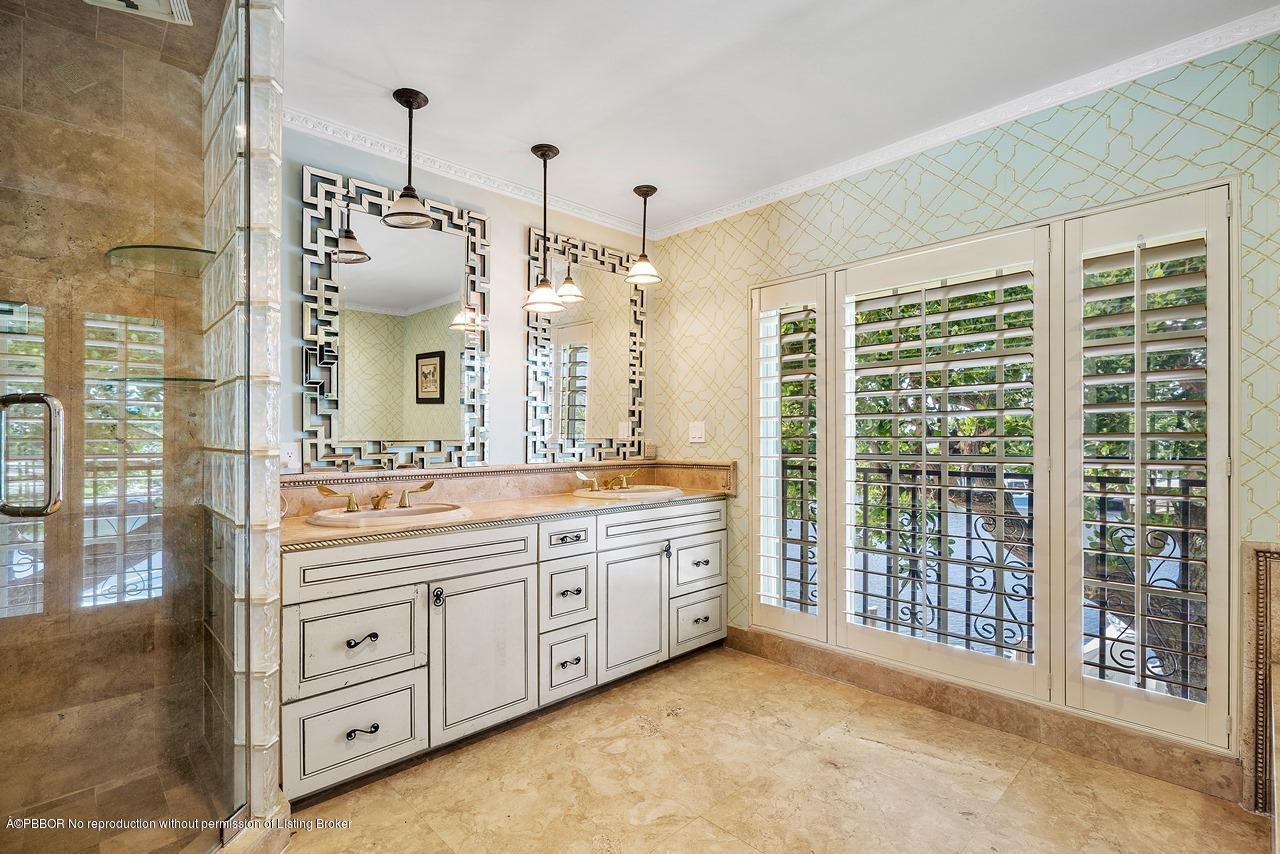 57 River Drive Ocean Ridge, FL 33435 - Photo 22 of 43 a spacious bathroom with a granite countertop sink mirror and shower