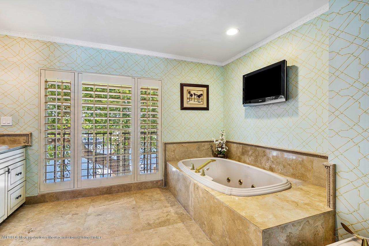 57 River Drive Ocean Ridge, FL 33435 - Photo 23 of 43 a bathroom with a bathtub and a flat screen tv