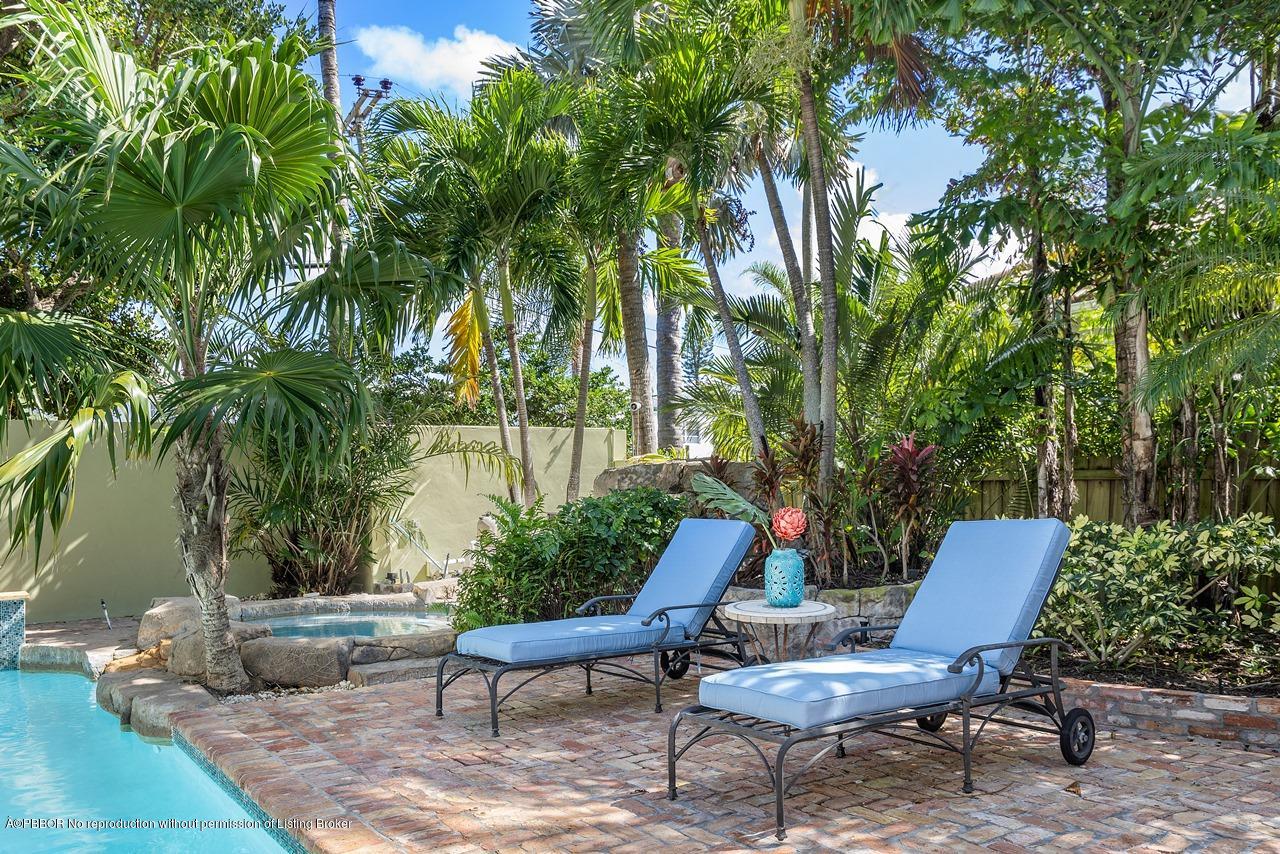 57 River Drive Ocean Ridge, FL 33435 - Photo 26 of 43 a view of a backyard with furniture and a fire pit