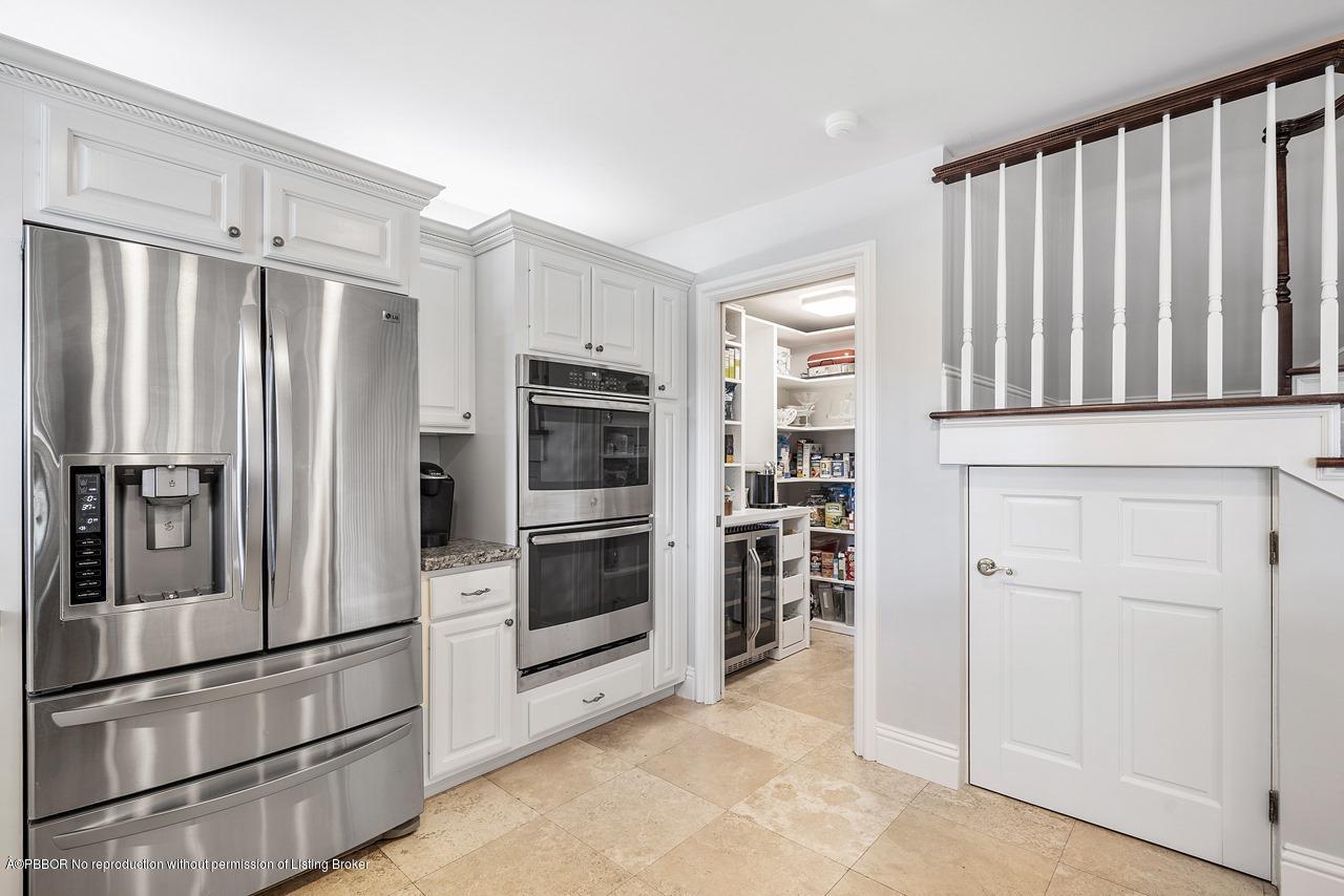 57 River Drive Ocean Ridge, FL 33435 - Photo 9 of 43 a kitchen with cabinets and stainless steel appliances