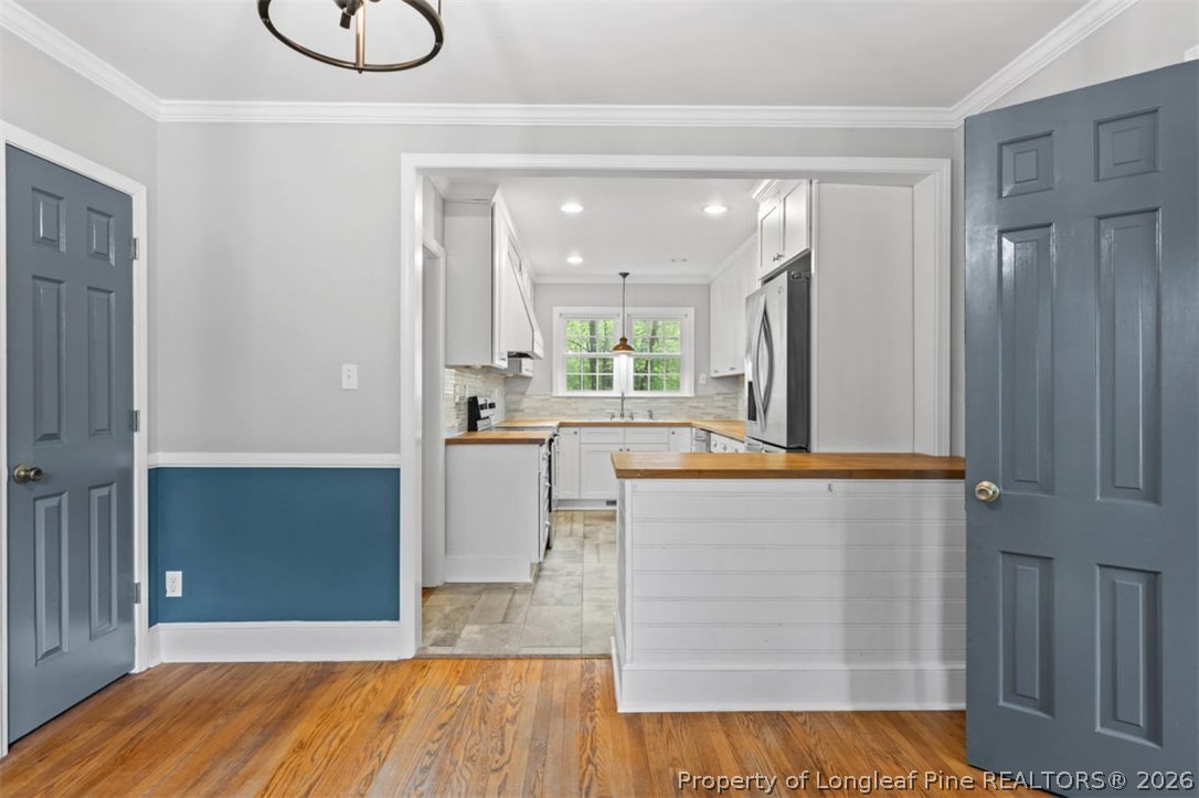 1007 Riverside Boulevard Lumberton, NC 28358 - Photo 11 of 42 a large kitchen with kitchen island granite countertop wooden cabinets and a sink