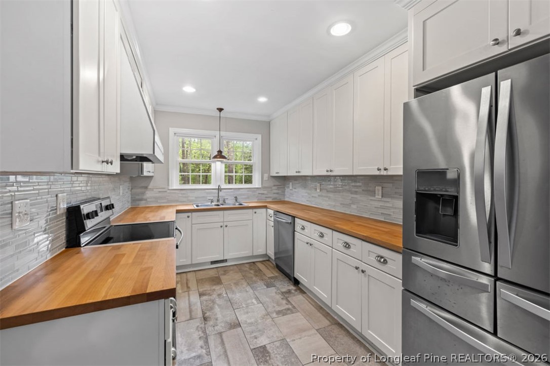 1007 Riverside Boulevard Lumberton, NC 28358 - Photo 12 of 42 a kitchen with granite countertop a sink stainless steel appliances and cabinets