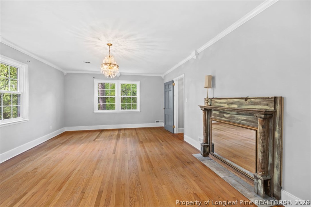 1007 Riverside Boulevard Lumberton, NC 28358 - Photo 22 of 42 a view of an empty room with wooden floor fireplace and a window