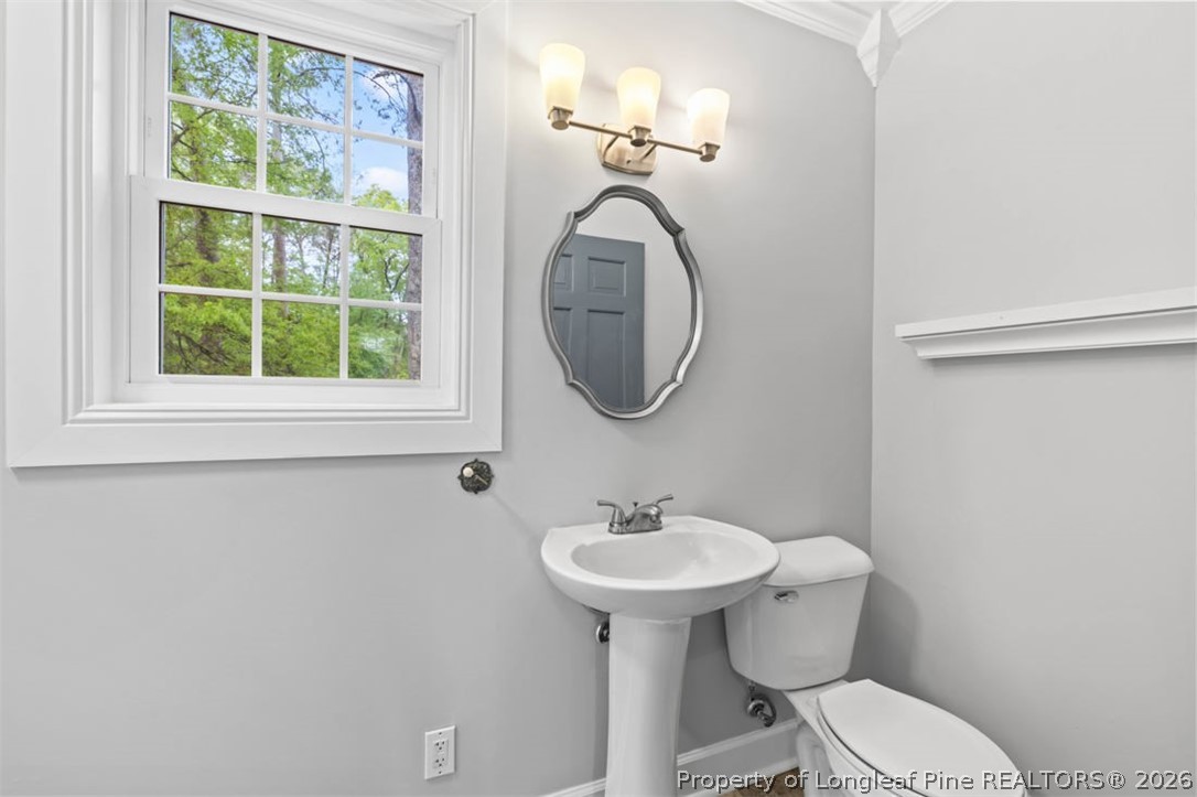 1007 Riverside Boulevard Lumberton, NC 28358 - Photo 30 of 42 a bathroom with a toilet sink and mirror
