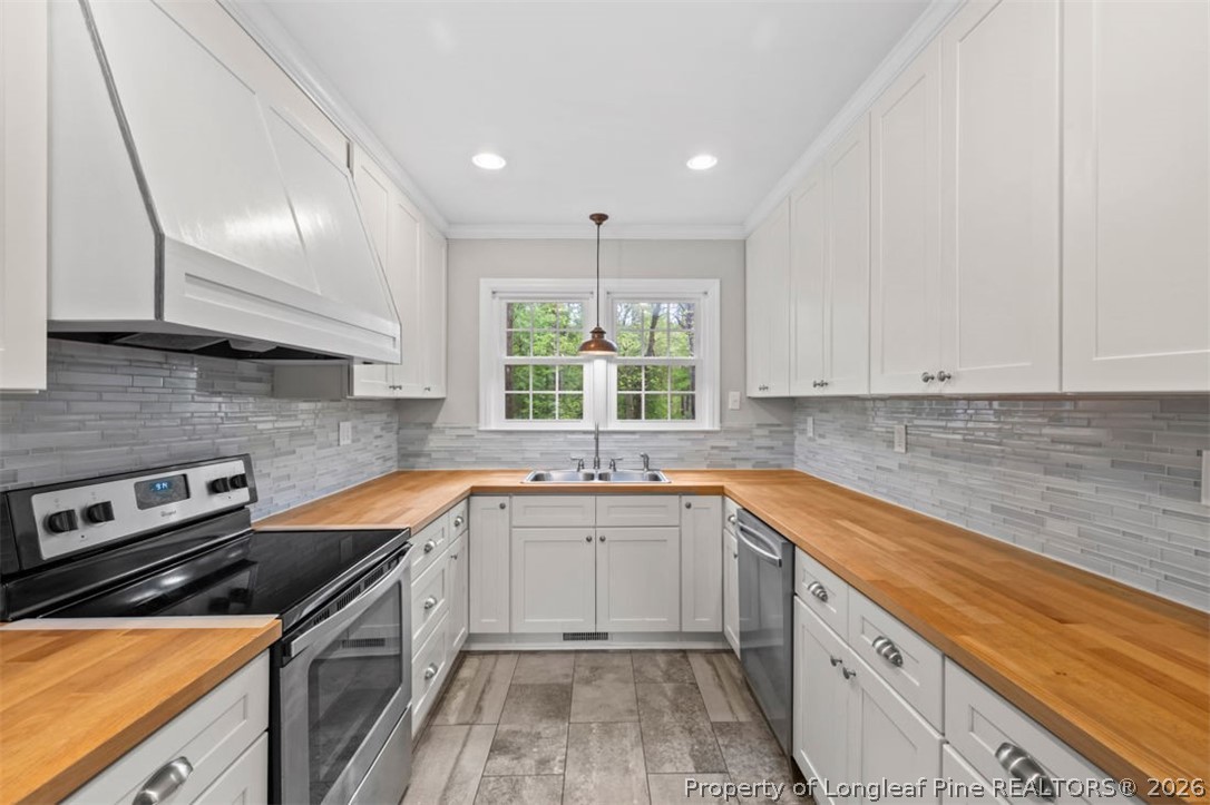 1007 Riverside Boulevard Lumberton, NC 28358 - Photo 4 of 42 a kitchen with a sink stove and cabinets