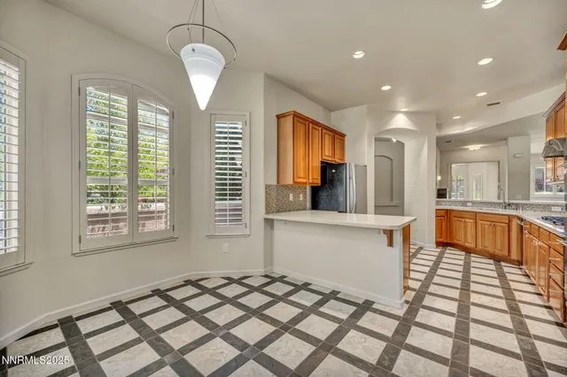 a kitchen with stainless steel appliances a refrigerator and a sink