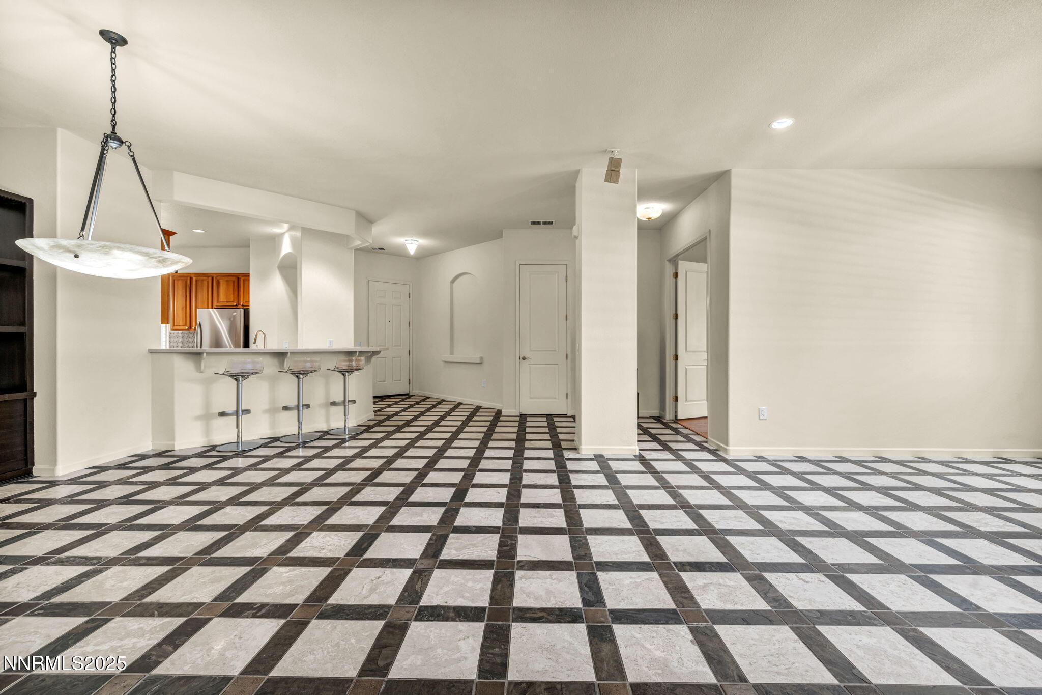 9900 Wilbur May Parkway, Unit 2801 Reno, NV 89521 - Photo 28 of 67 a living room with a black white checkered floor