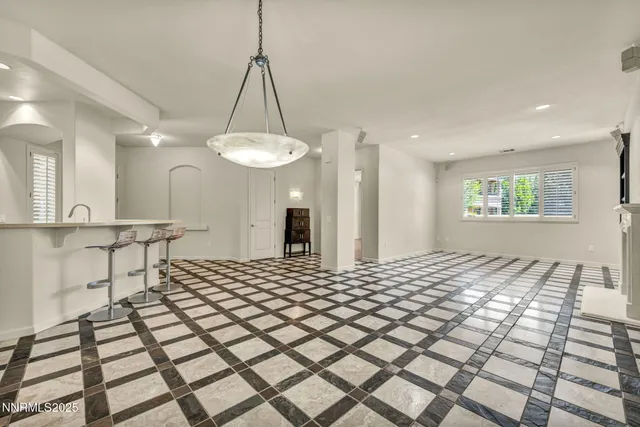 a kitchen with granite countertop a stove a sink and a refrigerator