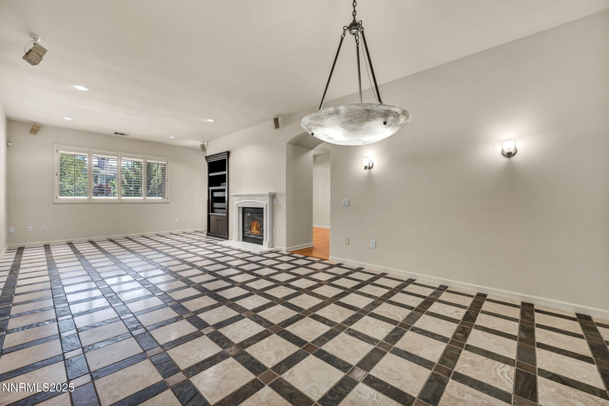 9900 Wilbur May Parkway, Unit 2801 Reno, NV 89521 - Photo 9 of 67 a bedroom with a bed and a chandelier