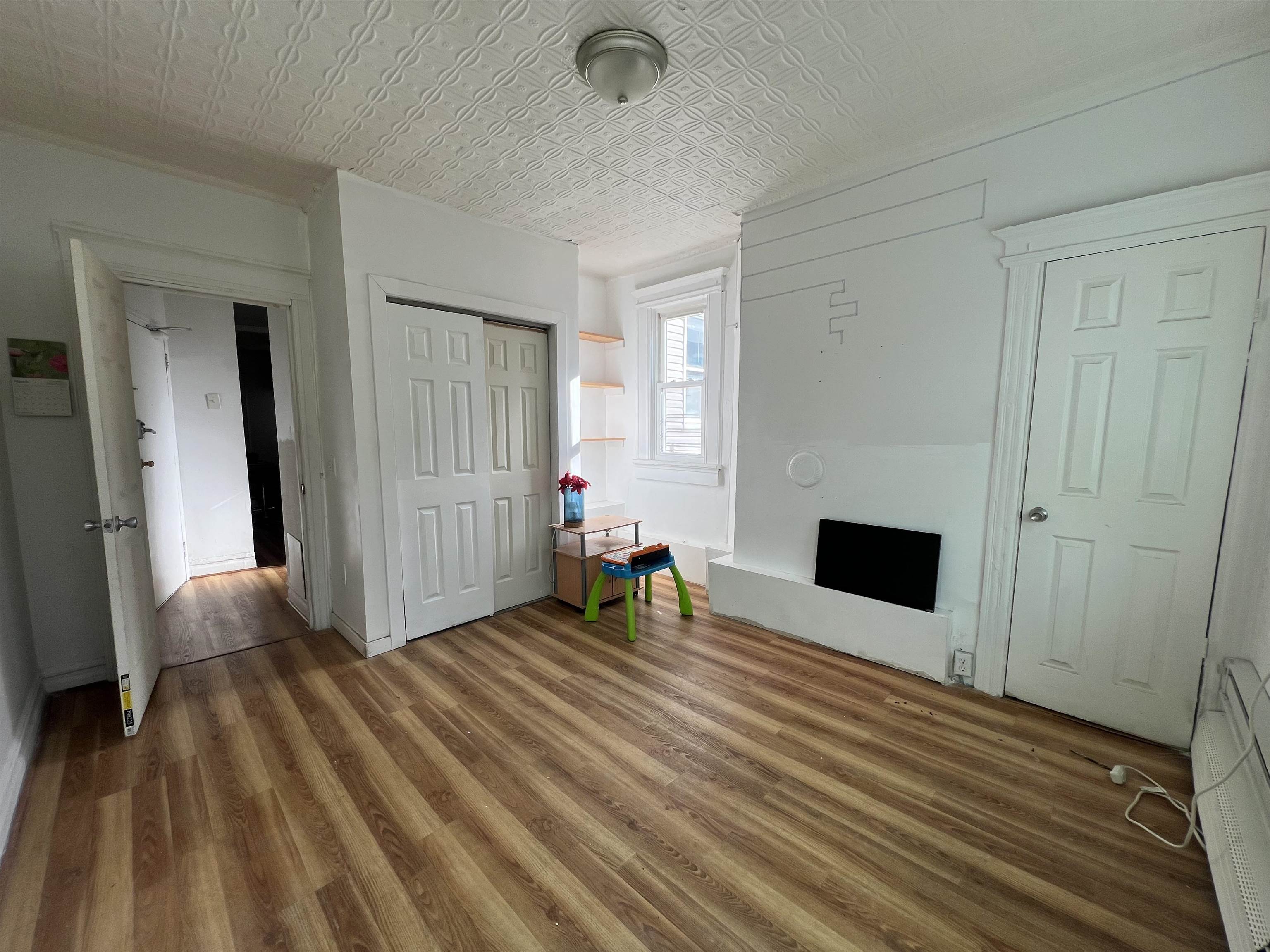 69 Clarke Avenue, Unit 2L Jersey City, NJ 07304 - Photo 3 of 8 a view of livingroom with furniture and fireplace