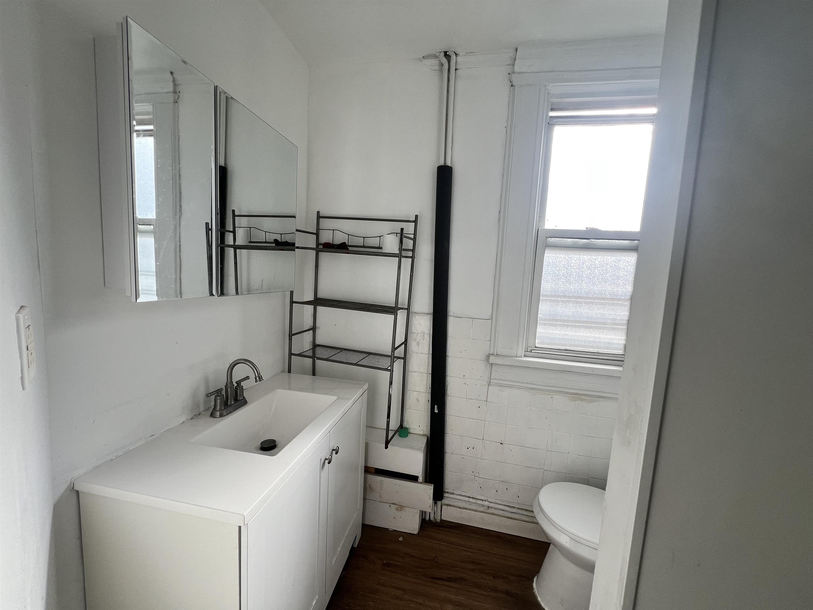 69 Clarke Avenue, Unit 2L Jersey City, NJ 07304 - Photo 5 of 8 a bathroom with a sink toilet and tub