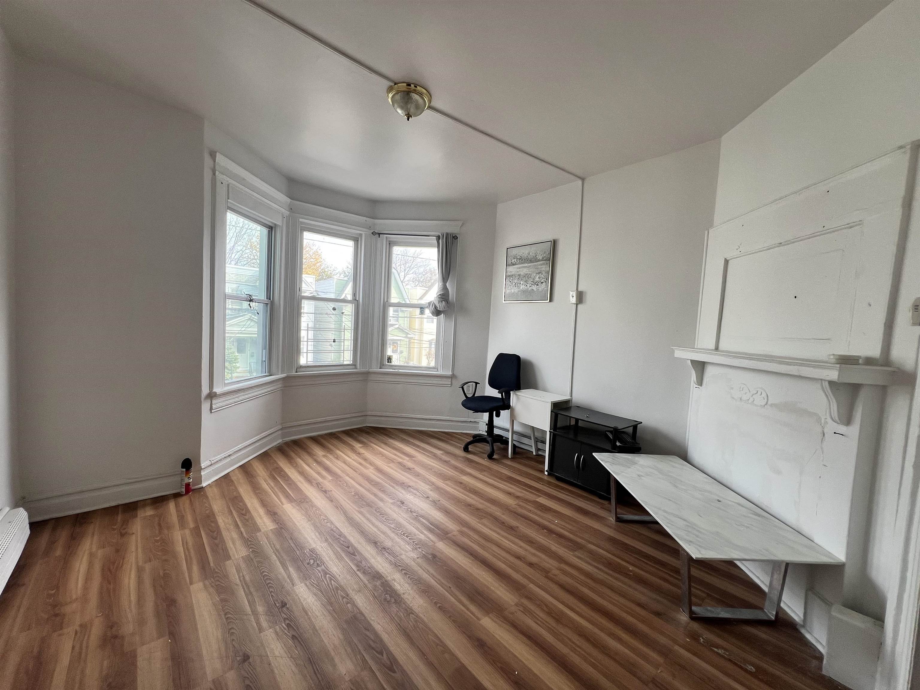 69 Clarke Avenue, Unit 2L Jersey City, NJ 07304 - Photo 7 of 8 a living room with furniture and a window