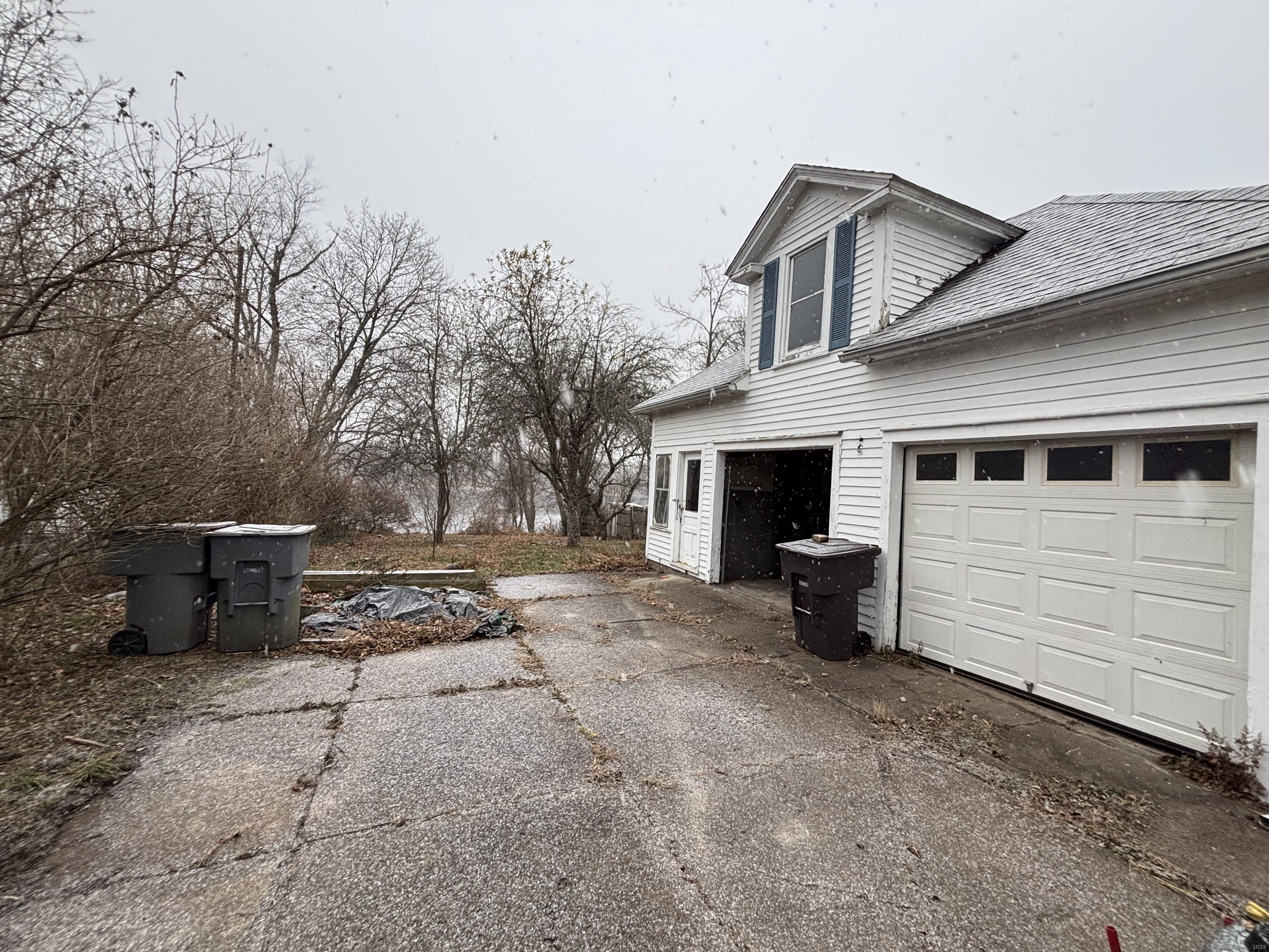 a view of a house with a yard and a garage