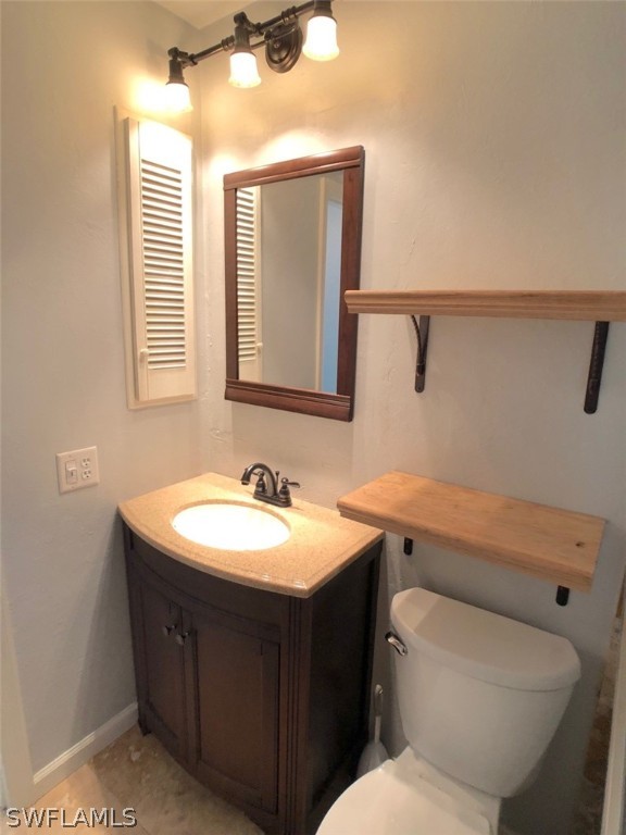 8038 Matanzas Road Fort Myers, FL 33967 - Photo 14 of 27 a bathroom with a toilet sink and mirror