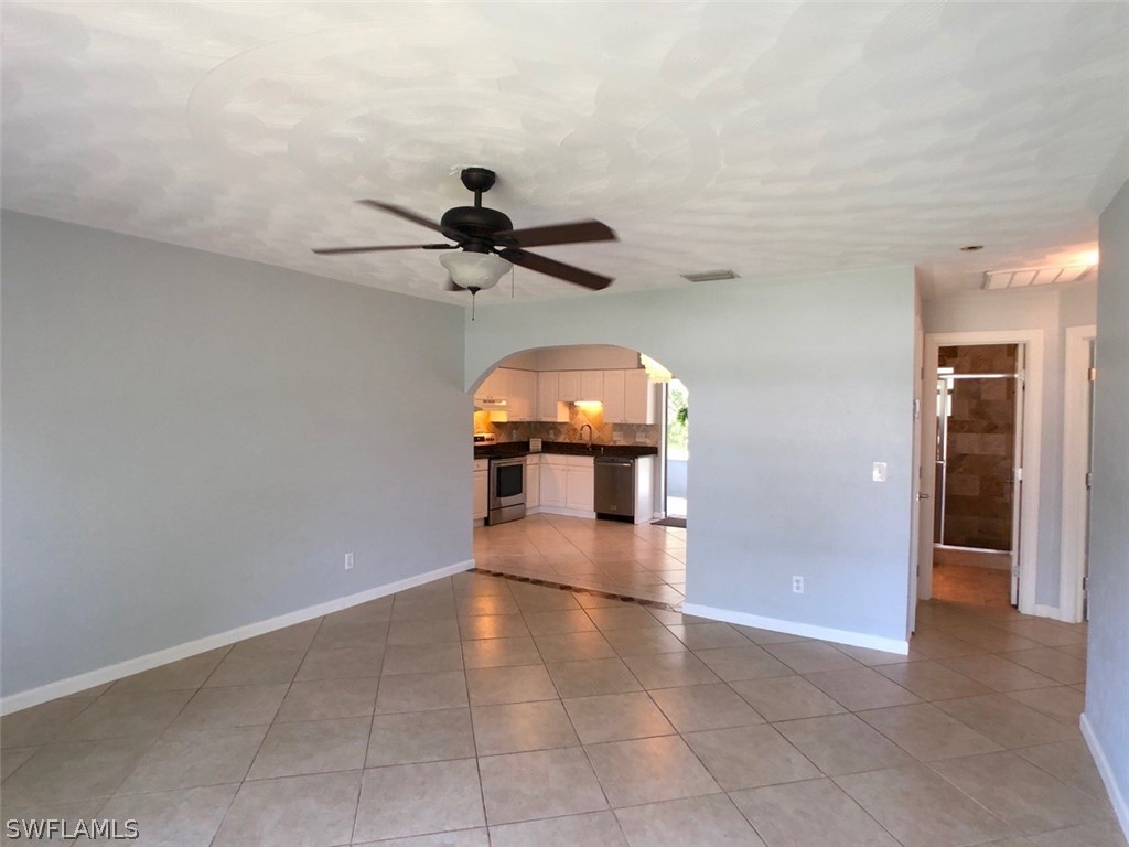 8038 Matanzas Road Fort Myers, FL 33967 - Photo 16 of 27 wooden floor in an empty room and a mirror