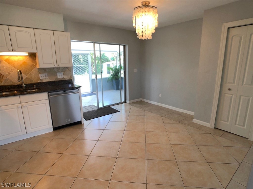 8038 Matanzas Road Fort Myers, FL 33967 - Photo 19 of 27 a kitchen with granite countertop a stove a sink and a refrigerator