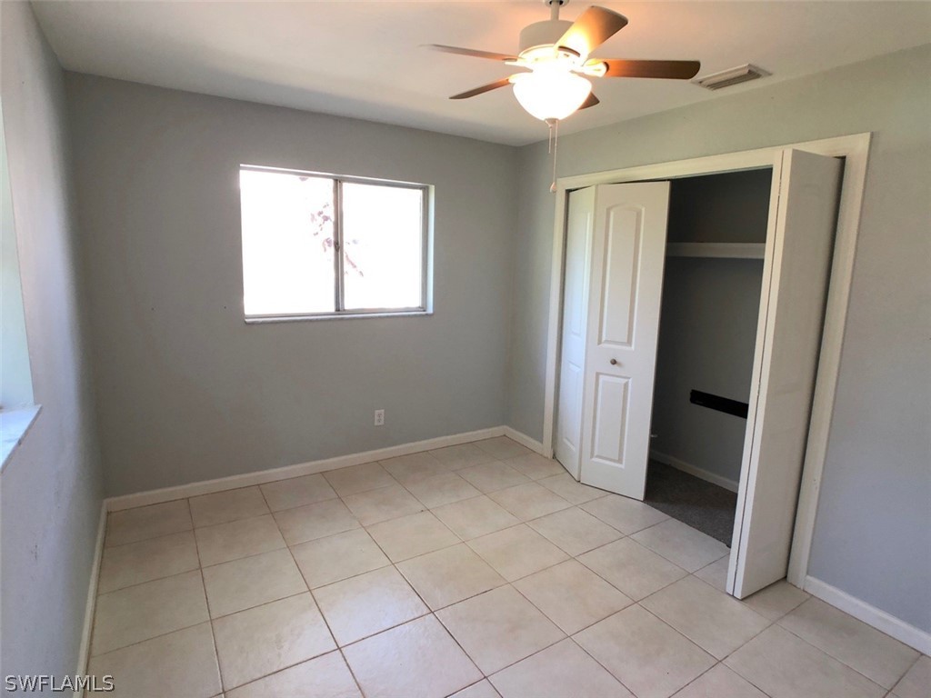 8038 Matanzas Road Fort Myers, FL 33967 - Photo 21 of 27 an empty room with a ceiling fan and a window