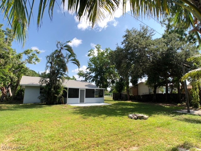 8038 Matanzas Road Fort Myers, FL 33967 - Photo 27 of 27 a front view of a house with a garden and yard