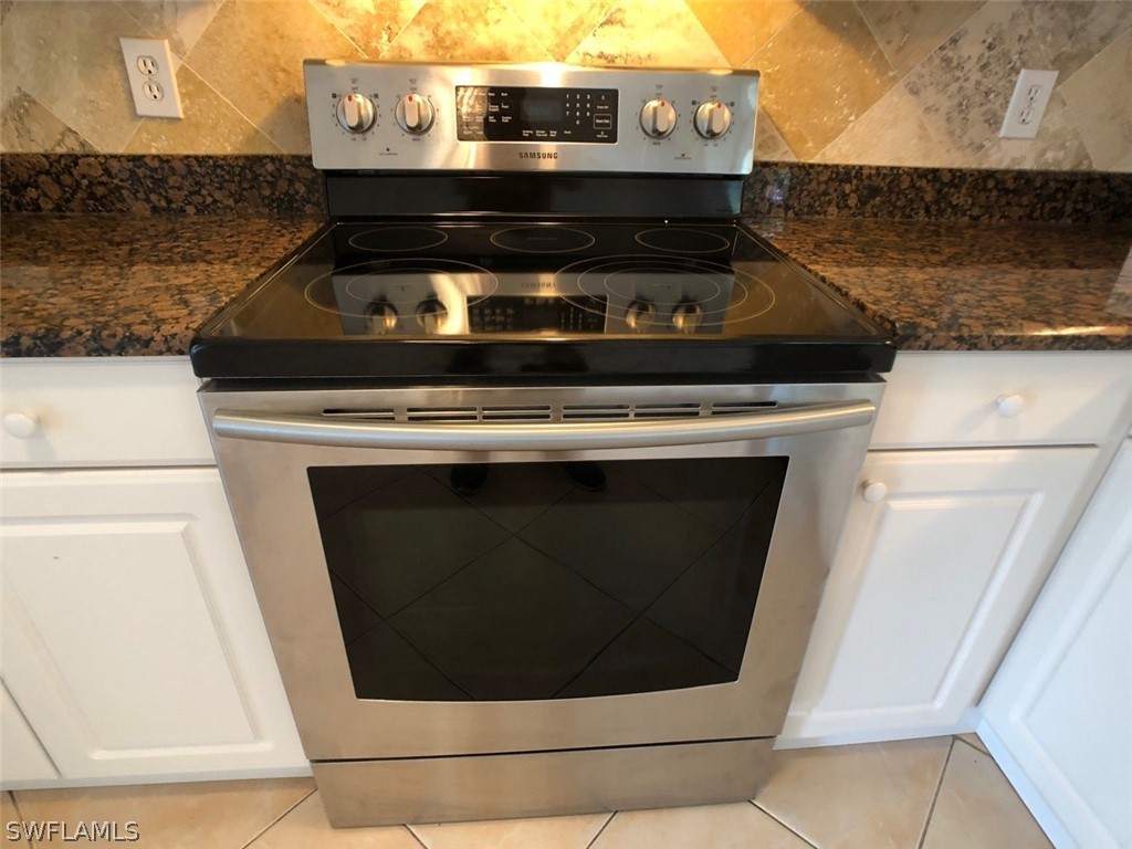 8038 Matanzas Road Fort Myers, FL 33967 - Photo 8 of 27 a stove top oven sitting inside of a kitchen