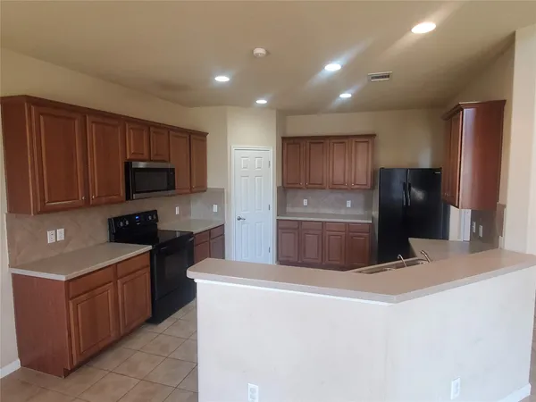 a kitchen with stainless steel appliances granite countertop a refrigerator stove a sink and dishwasher