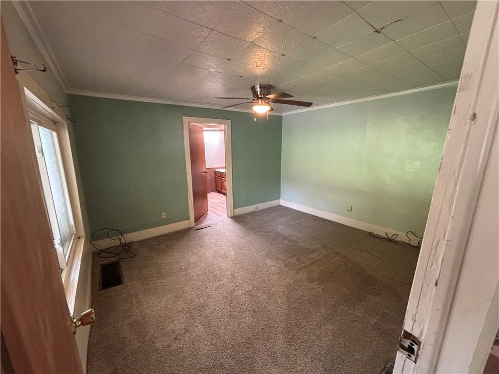 44 Bedford Road West Middlesex, PA 16159 - Photo 6 of 12 en empty room with windows and fan