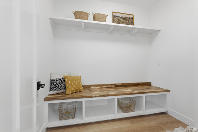 702 Alpine Highway Alpine, UT 84004 - Photo 35 of 83 Built-in entryway bench with a wood-finish top and white cabinetry featuring open storage compartments