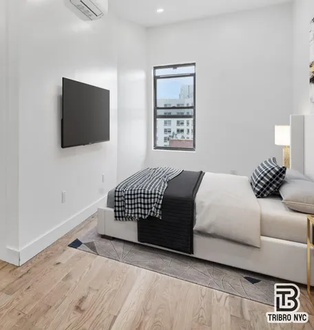 a bedroom with a bed and a flat screen tv