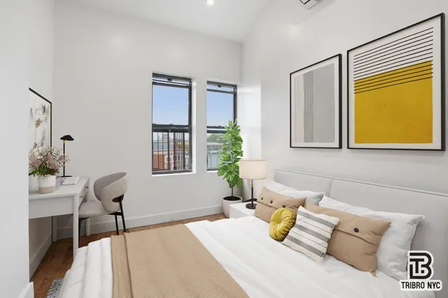 a bedroom with a bed and glass window