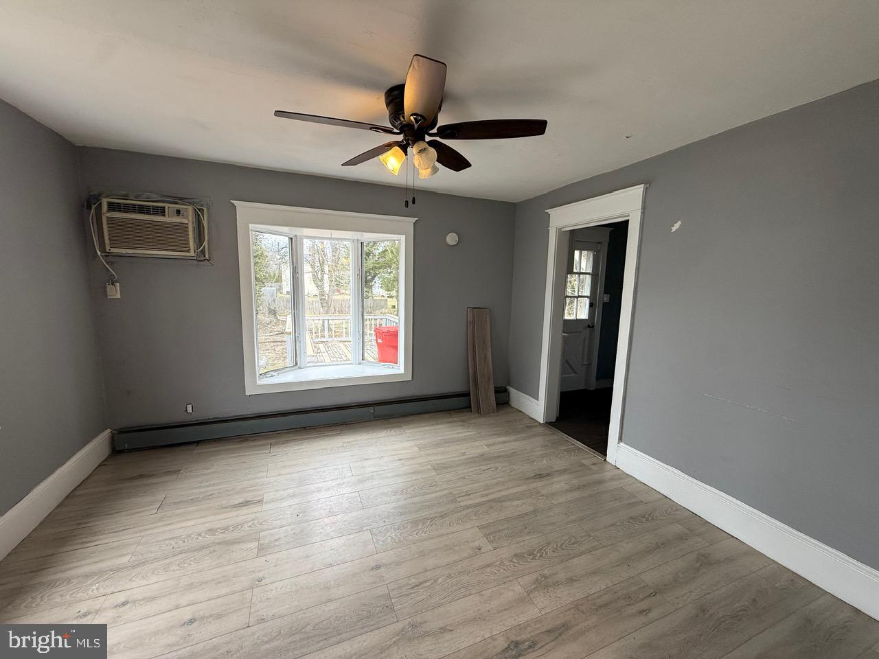 91 Summit Avenue Bridgeton, NJ 08302 - Photo 5 of 20 an empty room with wooden floor fan and windows
