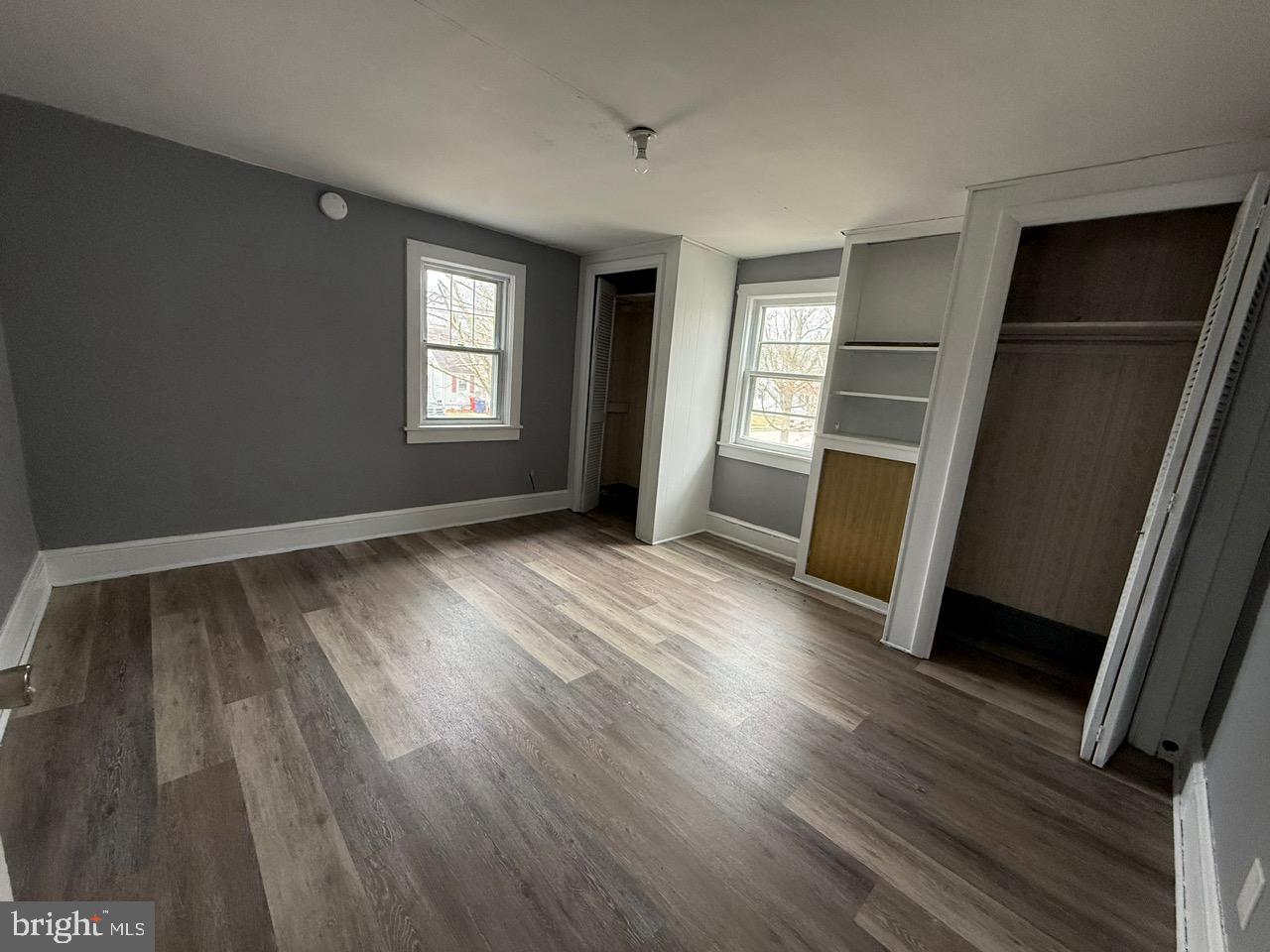 91 Summit Avenue Bridgeton, NJ 08302 - Photo 10 of 20 an empty room with wooden floor and windows