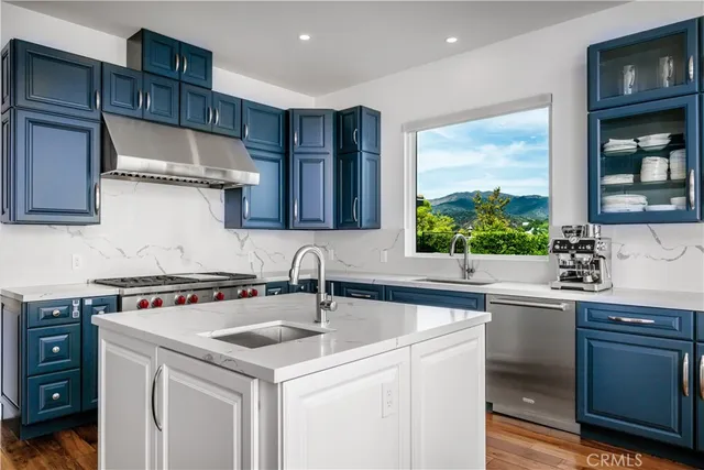 a kitchen with a sink cabinets and window