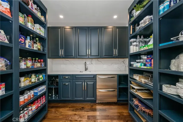 a kitchen with stainless steel appliances granite countertop a stove and cabinets