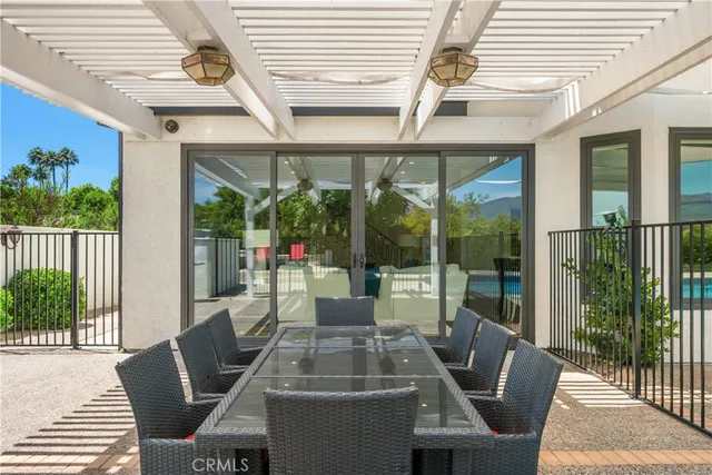 a dining room with furniture wooden floor and a potted plant