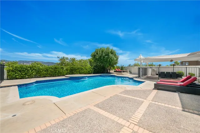 a view of swimming pool with seating space