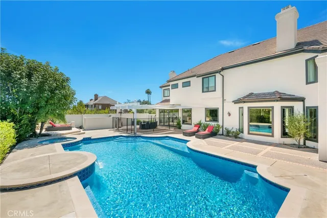 a view of a house with swimming pool and sitting area