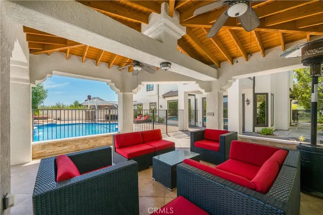 a living room with furniture a red rug and white walls