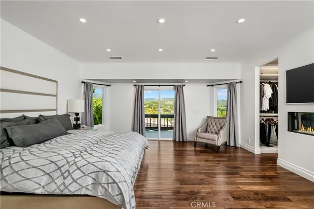 a bedroom with a large bed and a flat screen tv