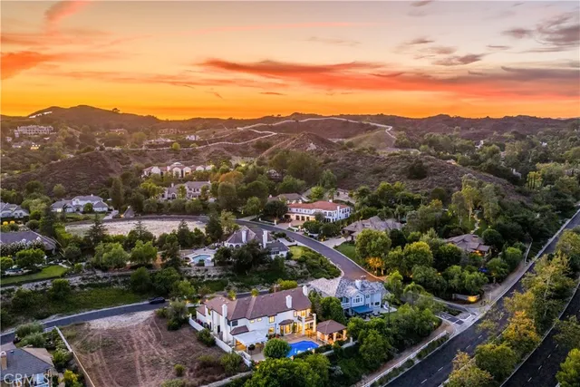 a view of a house with swimming pool and sitting area