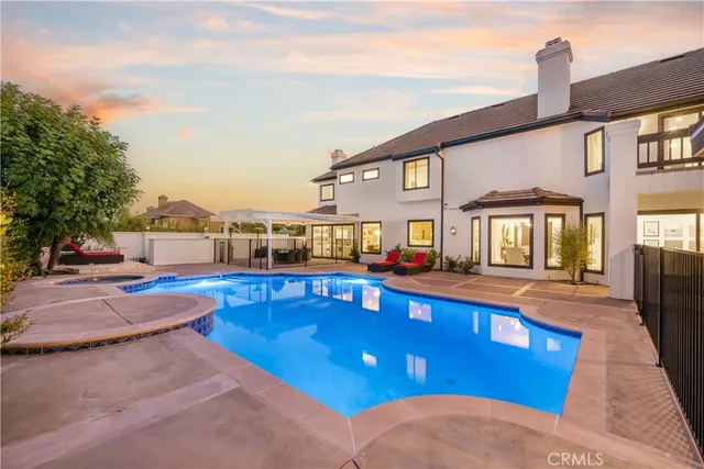 a view of a house with pool yard and sitting area