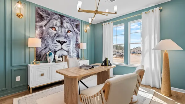 a living room with furniture kitchen view and a window